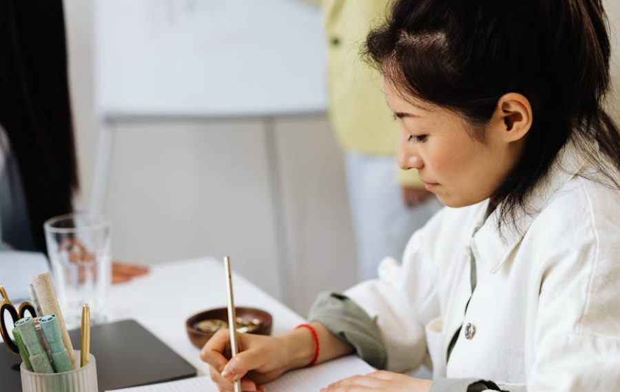 woman taking notes while in a meeting